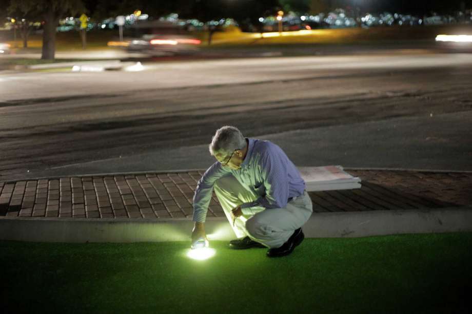 Robery Brydia tests luminocity of green paint with phone at night