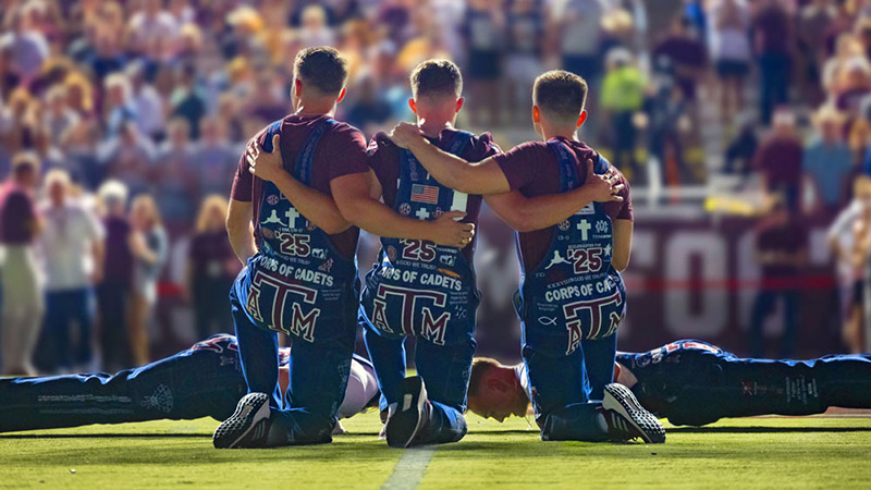 Yell Leaders kneeling at Kyle Field